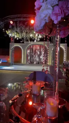 a table with candles and a vase with flowers at فندق سفن روزز in Amman