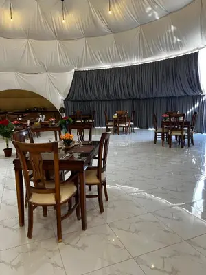 a dining room with tables and chairs in a tent at Rum Star Desert Camp in Wadi Rum
