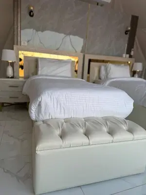 a white bed with a white couch in a bedroom at Rum Star Desert Camp in Wadi Rum
