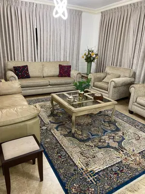 a living room with a couch and a coffee table at Beautiful & Cozy Newly remodeled 2 Bedroom in Amman