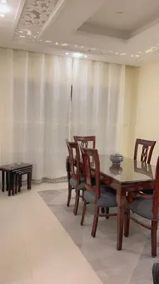 a dining room with a table and chairs at G Guest House in Amman