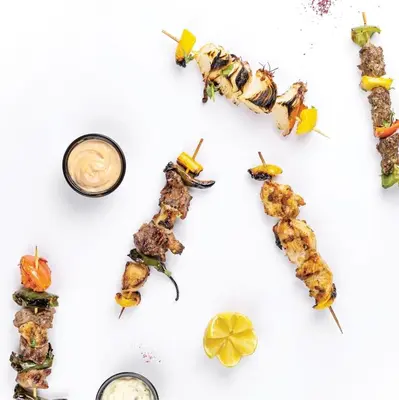 a group of food arranged in the shape of the word tx at JAZEERAT QUBTAN in Aqaba