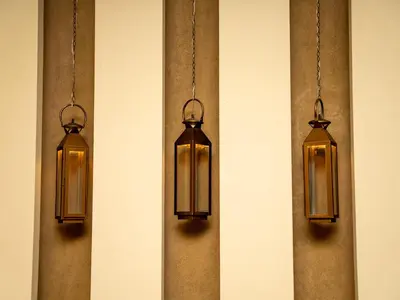 three lights are hanging on a wall at JAZEERAT QUBTAN in Aqaba