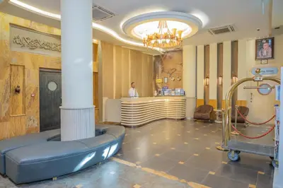 a lobby with a waiting room with a chair and a bar at JAZEERAT QUBTAN in Aqaba