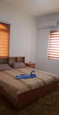 a large bed with a blue hose on top of it at Golden hotel in Jerash
