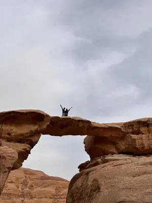 a person standing on top of a rock formation at 7stars in Disah