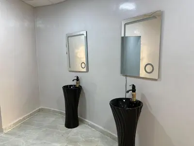 a bathroom with two black vases and a mirror at 7stars in Disah