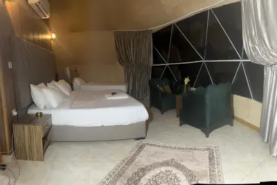 a hotel room with a bed and a chair at 7stars in Disah