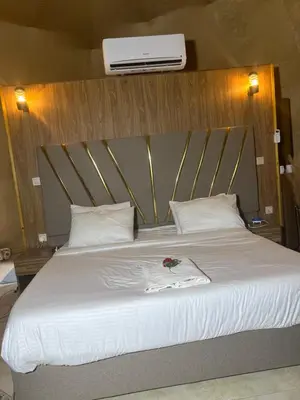 a bedroom with a bed with a white comforter at 7stars in Disah