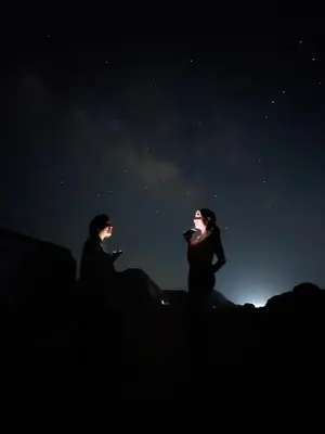 two people are looking up at the night sky at 7stars in Disah