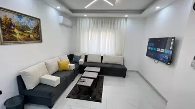 a living room with a couch and a tv at شقة بغرفه نوم واحدة عمو سامي in Amman