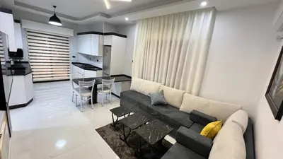 a living room with a couch and a kitchen at شقق عمو سامي بغرفة نوم 1 in Amman