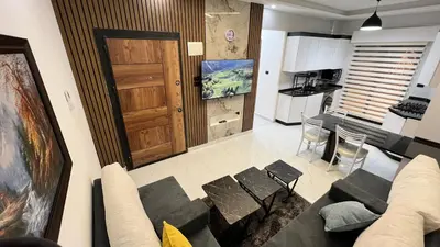 a living room with a couch and a kitchen at شقق عمو سامي بغرفة نوم 1 in Amman