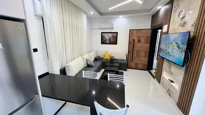 a living room with a table and a couch at شقق عمو سامي بغرفة نوم 1 in Amman