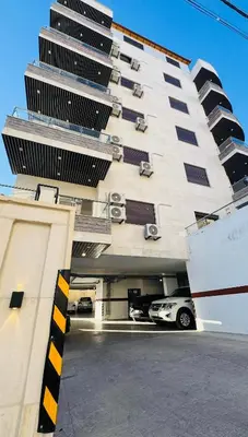 a parking garage with a car in front of a building at شقق عمو سامي بغرفتين نوم 2 in Amman