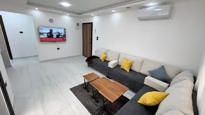 a living room with a couch and a tv at شقة رووف اطلاله رائعه عمو سامي 20 in Amman