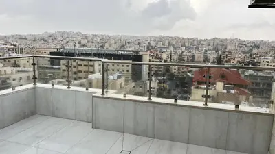 a balcony with a view of a city at شقة رووف اطلاله رائعه عمو سامي 20 in Amman