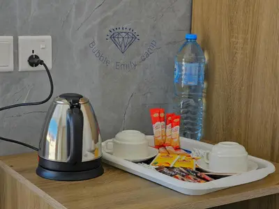 a tea kettle and a bottle of water on a table at Bubble Emily camp in Wadi Rum