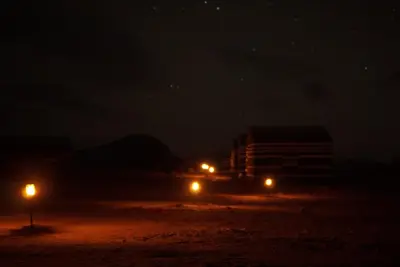 a night view of a building and street lights at Moon shine camp in Wadi Rum