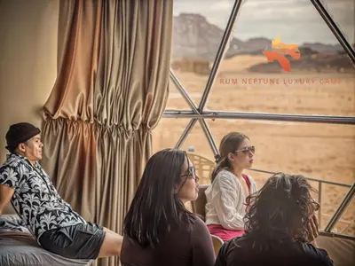 a group of women sitting in front of a window at RUM NEPTUNE lUXURY CAMP in Wadi Rum