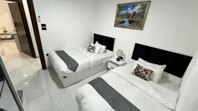 a hotel room with two beds and a mirror at شقة بثلاث غرف نوم 3 عمو سامي in Amman
