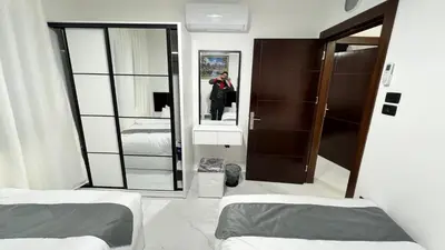 a person taking a picture of a mirror in a room at شقة بثلاث غرف نوم 3 عمو سامي in Amman