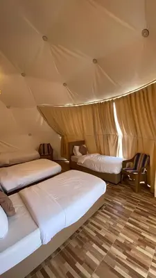 a room with two beds in a tent at Romantic Moment Rum CAMP in Wadi Rum