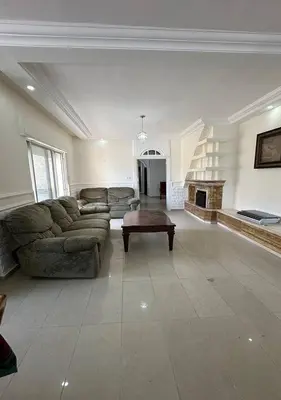 a large living room with a couch and a fireplace at Tlaa al ali amman 3 rooms furnished apartment المحكمة الدستورية in Umm Uthainah