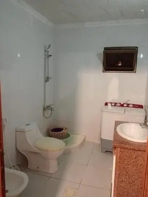 a bathroom with a toilet and a sink at Bait al salam in Um Qeis