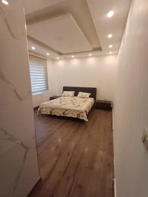 a bedroom with a bed in a room at Apartment in Khalda in Amman
