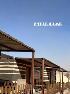 a wooden building with a roof with a sign that reads starcussion at 7star camp in Wadi Rum
