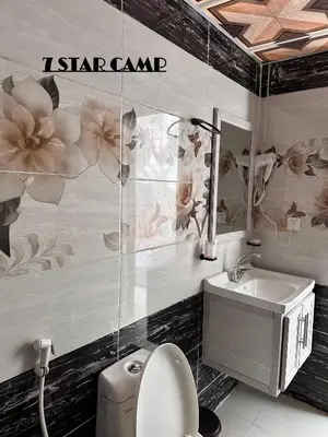 a bathroom with a sink and a toilet and a mirror at 7star camp in Wadi Rum