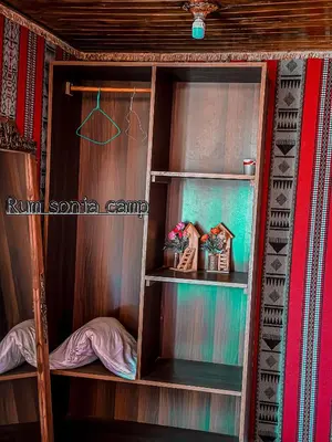 a wooden closet with two shelves in a room at sonia luxury camp in Wadi Rum