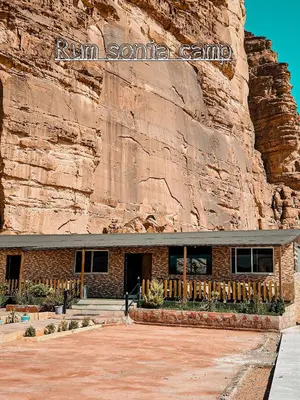 a building in front of a rock wall at sonia luxury camp in Wadi Rum