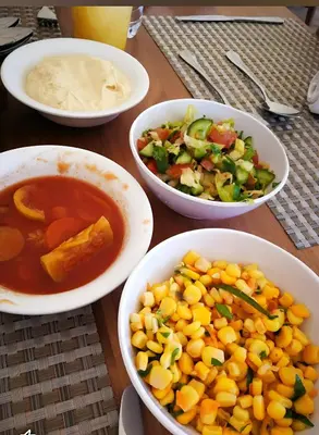 a table with bowls of food and a bowl of soup at Rum Honeymoon Camp in Wadi Rum