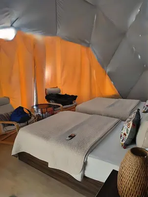 a room with two beds in a tent at Rum Green Camp in Wadi Rum