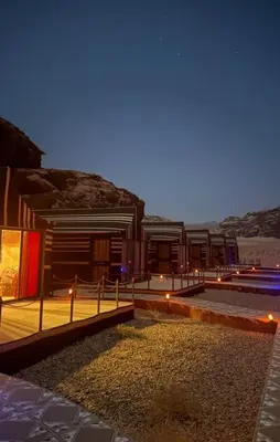 a rendering of a building with lights in the desert at Wadi rum stay & tours in Wadi Rum