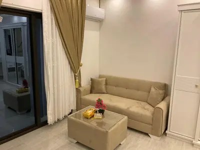 a living room with a couch and a coffee table at استديو فندقي راقي in Amman