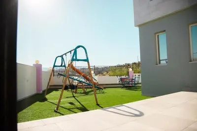 a playground on the balcony of a house at Gerasa Breeze resort in Rujm al Miḑmār