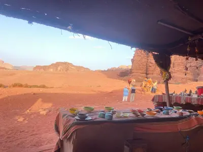 a table in the desert with bowls on it at Salem Wadi Rum Road in Wadi Rum