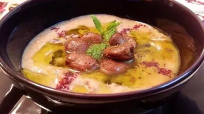 a bowl of soup with meatballs in it at Samira House in Amman