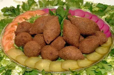 a plate of food with meatballs and vegetables on it at Samira House in Amman