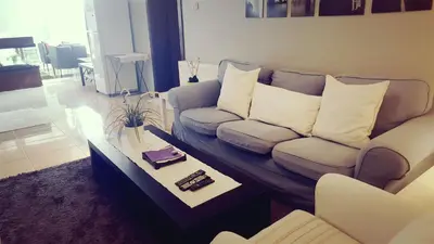 a living room with a couch and a coffee table at Two Bedroom Shmeisani Apartment in Amman