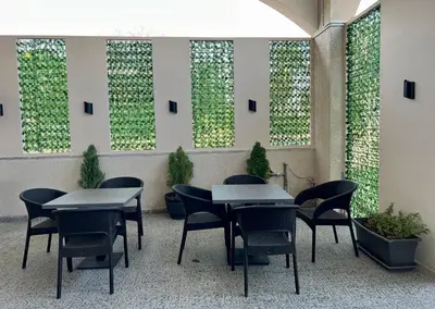 a group of tables and chairs in a room with plants at Saraya Abdeen Hotel in Aqaba