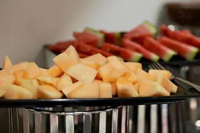 a plate of cut up fruit and watermelon at Saraya Abdeen Hotel in Aqaba