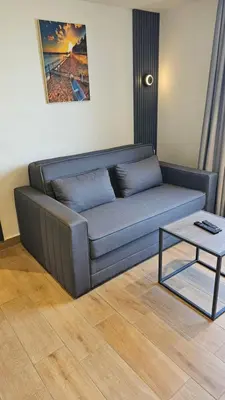 a couch in a living room with a coffee table at Saraya Abdeen Hotel in Aqaba