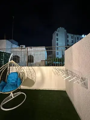 a bird cage sitting on the side of a wall at Stylish Luxe Apartment F/R 0002 in Amman
