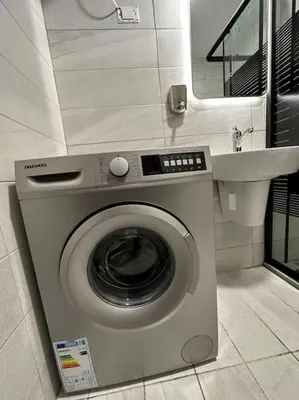 a washing machine in a bathroom with a sink at Stylish Luxe Apartment F/R 0002 in Amman