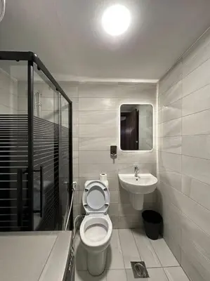 a bathroom with a toilet and a sink at Stylish Luxe Apartment F/R 0004 in Amman