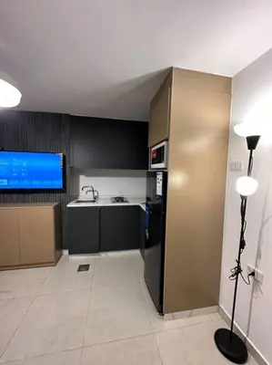 a kitchen with a sink and a refrigerator and a stove at Stylish Luxe Apartment F/R 0005 in Amman